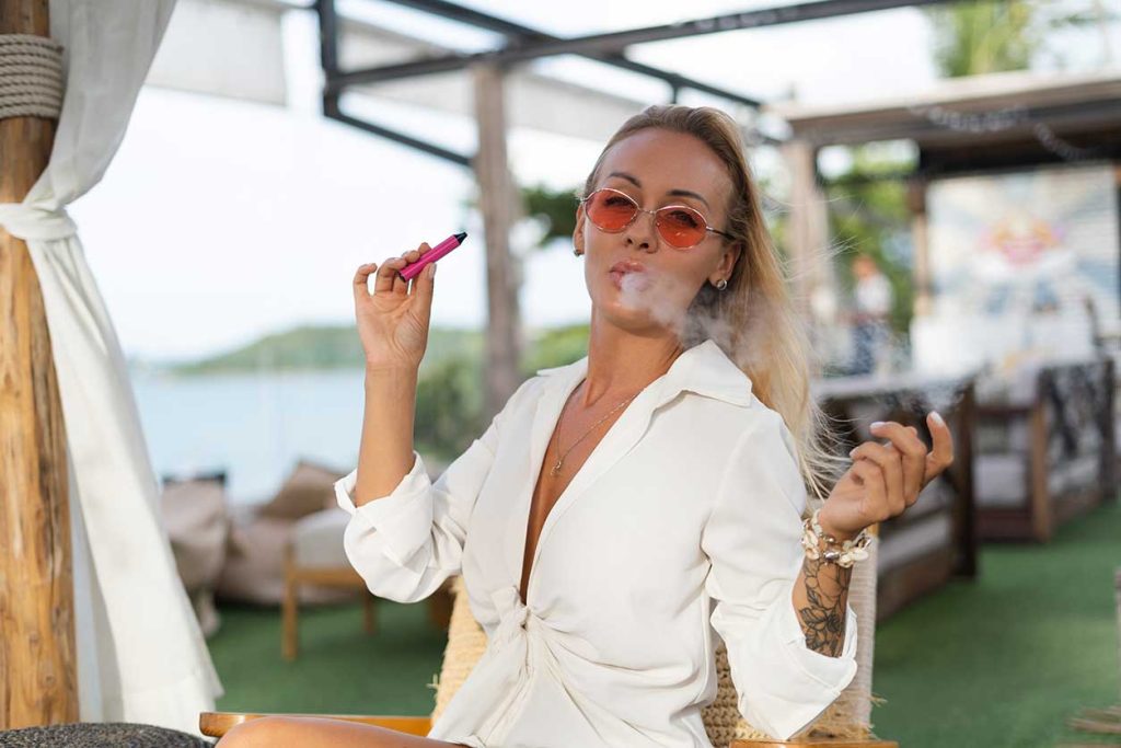 Blonde woman in New Jersey with a Fire OG vape pen